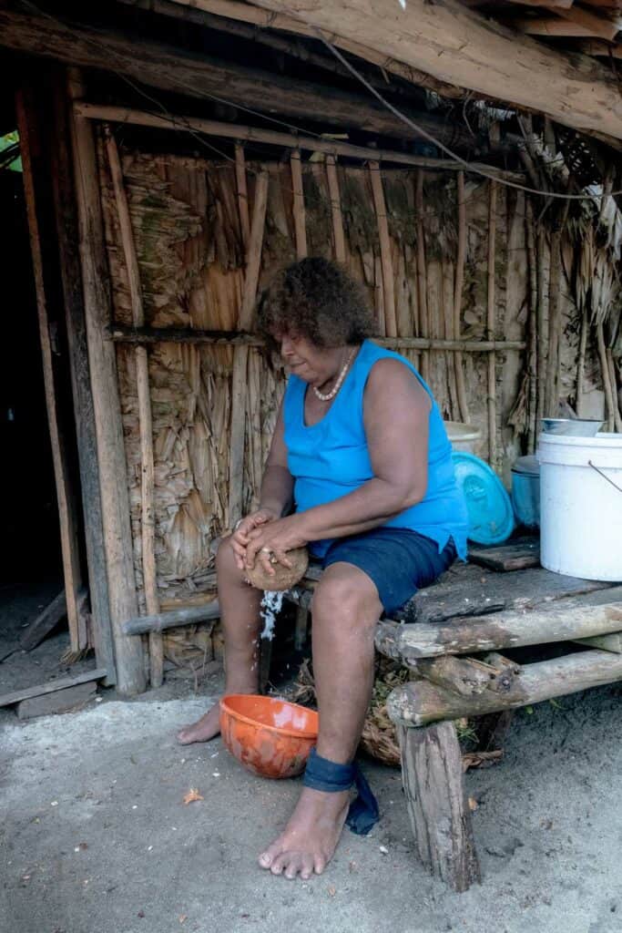 Lady Husking Coconut