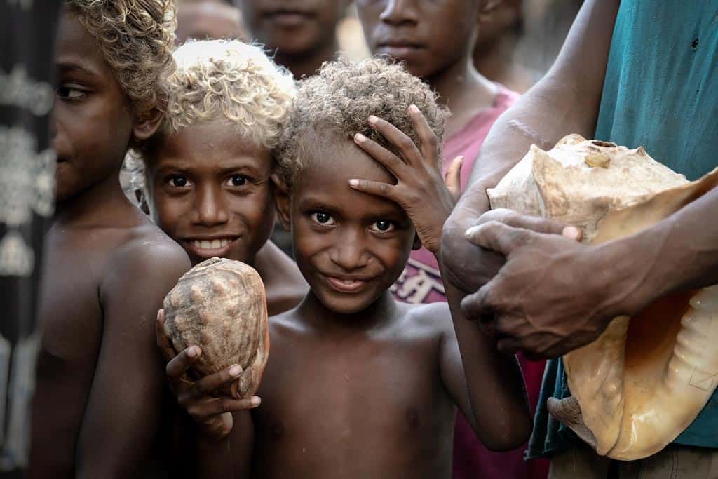 A Young Boy Holds A Conch Shell On Santa Catalina.