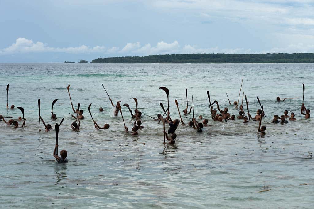 Boys Wave Their Spears In The Air.
