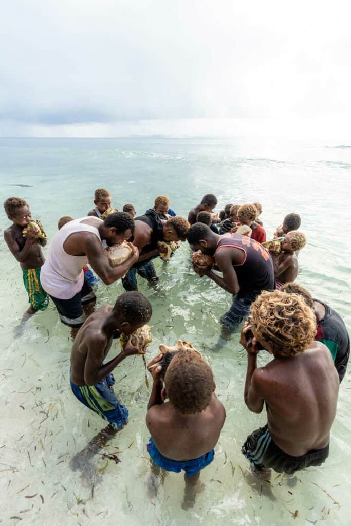 Blowing Conch Shells In The Sea