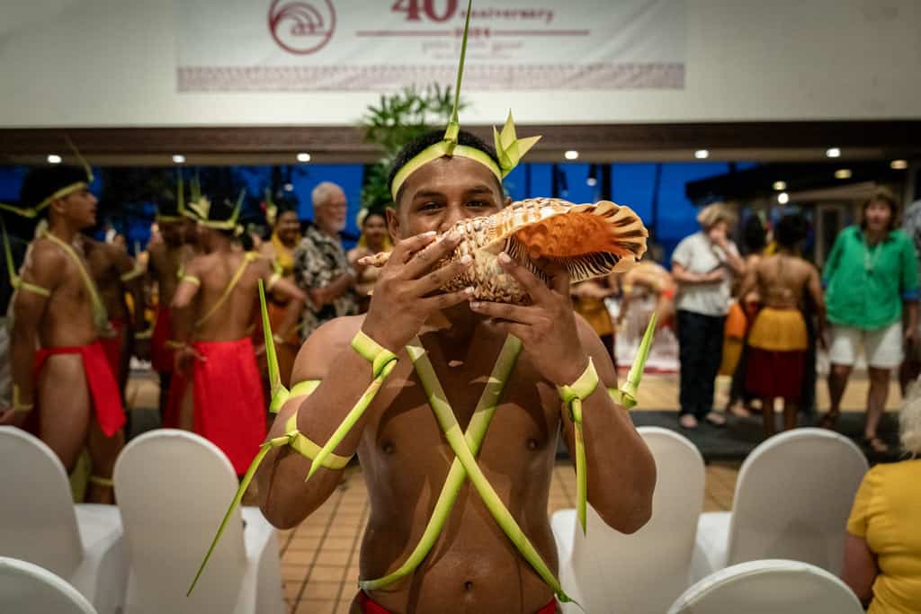 Man Blowing Conch Shell