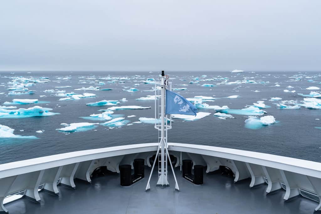 A Cruise Ship Sailing Through The Frigid Wonders Of Antarctica