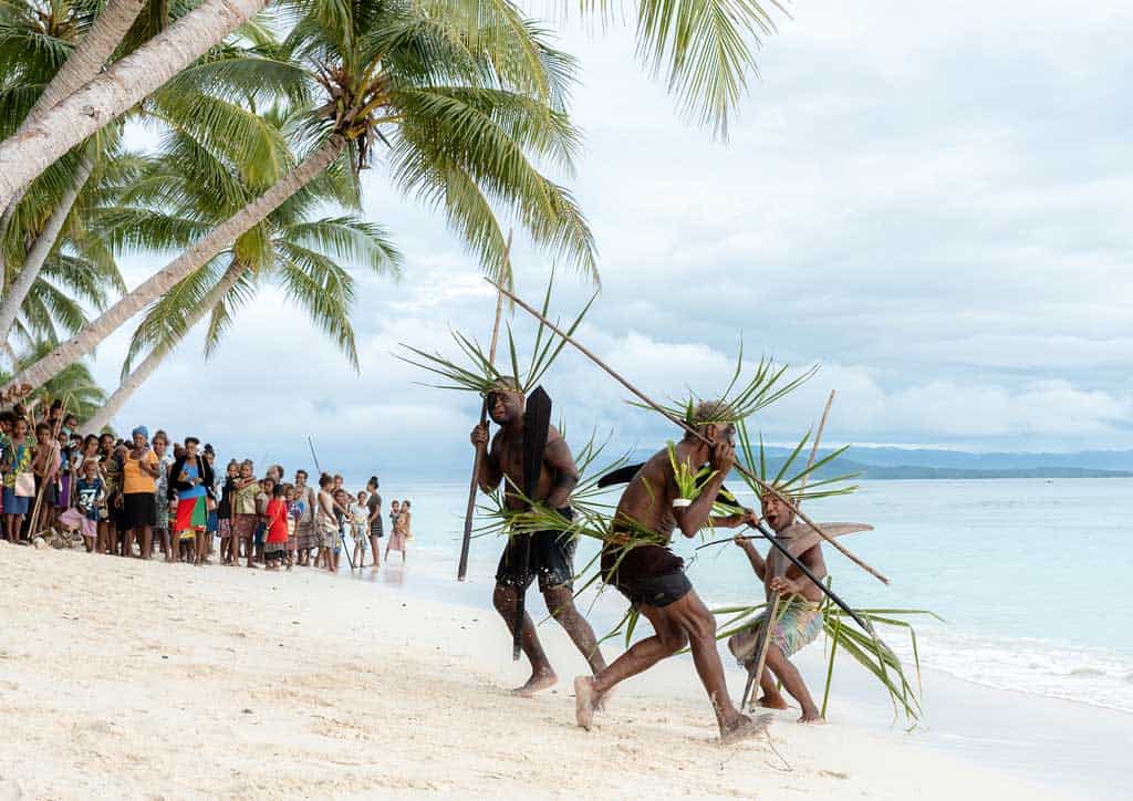 Three Warriors Run Onto The Beach.